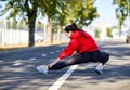 Girl on a warm-up in the street in the park