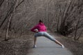 Young beautiful girl warming up before a jog in the Park Royalty Free Stock Photo