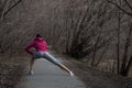 Young beautiful girl warming up before a jog in the Park Royalty Free Stock Photo