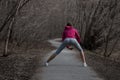 Young beautiful girl warming up before a jog in the Park Royalty Free Stock Photo