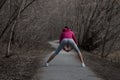 Young beautiful girl warming up before a jog in the Park Royalty Free Stock Photo