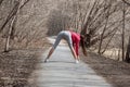 Young beautiful girl warming up before a jog in the Park Royalty Free Stock Photo