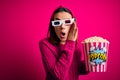 Young beautiful girl watching movie using 3d glasses eating box with popcorns hand on mouth telling secret rumor, whispering Royalty Free Stock Photo