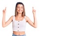 Young beautiful girl wearing casual sleeveless t shirt gesturing finger crossed smiling with hope and eyes closed Royalty Free Stock Photo