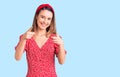 Young beautiful girl wearing dress and diadem pointing fingers to camera with happy and funny face Royalty Free Stock Photo