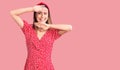 Young beautiful girl wearing dress and diadem smiling cheerful playing peek a boo with hands showing face Royalty Free Stock Photo