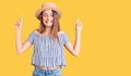 Young beautiful girl wearing hat and t shirt gesturing finger crossed smiling with hope and eyes closed Royalty Free Stock Photo