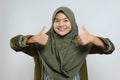 Young beautiful girl wearing muslim hijab approving doing positive gesture with hand, thumbs up smiling and happy for success Royalty Free Stock Photo