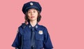 Young beautiful girl wearing police uniform relaxed with serious expression on face Royalty Free Stock Photo