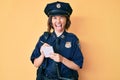 Young beautiful girl wearing police uniform writing traffic fine sticking tongue out happy with funny expression Royalty Free Stock Photo