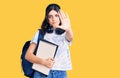 Young beautiful girl wearing student backpack holding notebook with open hand doing stop sign with serious and confident Royalty Free Stock Photo