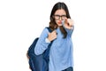 Young beautiful girl wearing student backpack pointing with finger to the camera and to you, confident gesture looking serious Royalty Free Stock Photo