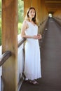 Young beautiful girl in a white dress close-up on the aqueduct bridge background