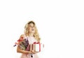 Young beautiful girl with a white gift with a red bow, flowers and balls in her hands rejoices on an isolated white background. Royalty Free Stock Photo