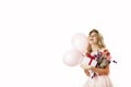 Young beautiful girl with a white gift with a red bow, flowers and balls in her hands rejoices on an isolated white background. Royalty Free Stock Photo