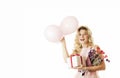 Young beautiful girl with a white gift with a red bow, flowers and balls in her hands rejoices on an isolated white background. Royalty Free Stock Photo