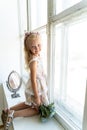 Young beautiful girl in white room