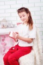 Young beautiful girl wonderingly looking in present box Royalty Free Stock Photo