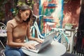 A young beautiful girl working on a laptop while sitting in the bar. Leisure, bar, outdoor Royalty Free Stock Photo