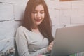 Young beautiful girl working at a laptop in a small medium enterprise Royalty Free Stock Photo