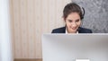 Young beautiful girl working at a laptop in a small medium enterprise Royalty Free Stock Photo