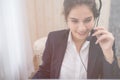 Young beautiful girl working at a laptop in a small medium enterprise Royalty Free Stock Photo