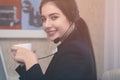 Young beautiful girl working at a laptop in a small medium enterprise Royalty Free Stock Photo