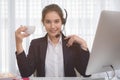 Young beautiful girl working at a laptop in a small medium enterprise Royalty Free Stock Photo