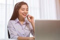 Young beautiful girl working at a laptop in a small medium enterprise Royalty Free Stock Photo