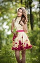 Young beautiful girl in a yellow dress in the woods. Portrait of romantic woman in fairy forest. Stunning fashionable teenager Royalty Free Stock Photo