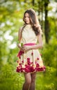 Young beautiful girl in a yellow dress in the woods. Portrait of romantic woman in fairy forest. Stunning fashionable teenager Royalty Free Stock Photo