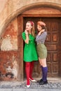 Young beautiful girls dressed in retro vintage style enjoying the old european city lifestyle while looking surprised