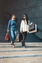 Beautiful girls with paper bags outside shopping mall Royalty Free Stock Photo