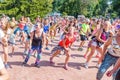 young and beautiful girls and women are engaged in sports dancing on the Volga River Embankment on a summer sunny day