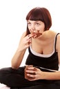 Young beautiful glutton eat chocolate isolated