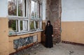 Young goth woman stands in the room of an abandoned house Royalty Free Stock Photo