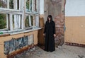 Young goth woman stands in the room of an abandoned house Royalty Free Stock Photo