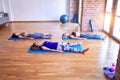 Young beautiful group of sportswomen practicing yoga