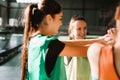 Young beautiful group of sportswomen standing shaking hands after class of sport training at gym. Strong team spirit Royalty Free Stock Photo