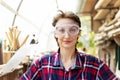 Young beautiful handy professional happy female strong carpenter portrait wearing protective goggles working in carpentry diy Royalty Free Stock Photo