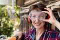 Young beautiful handy professional happy female strong carpenter portrait wearing protective goggles working in carpentry diy Royalty Free Stock Photo