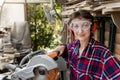 Young beautiful handy professional happy female strong carpenter portrait wearing protective goggles working in carpentry diy Royalty Free Stock Photo