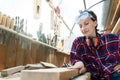 Young beautiful handy professional happy female strong carpenter portrait wearing protective goggles working in carpentry diy Royalty Free Stock Photo