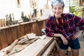 Young beautiful handy professional happy female strong carpenter portrait wearing protective goggles working in Royalty Free Stock Photo