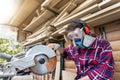 Young beautiful handy professional happy female strong carpenter portrait wearing protective goggles working in Royalty Free Stock Photo