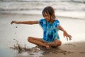 Young beautiful and happy Asian American mixed ethnicity child girl 7 or 8 years old playing with sand having fun enjoying Summer Royalty Free Stock Photo