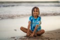 Young beautiful and happy Asian American mixed ethnicity child girl 7 or 8 years old playing with sand having fun enjoying Summer Royalty Free Stock Photo