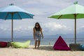 Young beautiful and happy Asian Chinese woman in chic Summer dress and sunglasses posing relaxed at tropical beach relaxed at nice Royalty Free Stock Photo