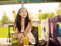 Young beautiful and happy Asian Chinese woman drinking orange juice eating healthy salad at organic food coffee shop outdoors enjo Royalty Free Stock Photo