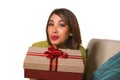 Young beautiful and happy Asian Indonesian woman holding birthday or Christmas present showing the gift box cheerful and excited Royalty Free Stock Photo